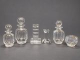 several glass objects are arranged on a table with a gray background