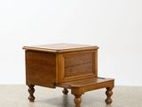 a small wooden table with a drawer on top of it