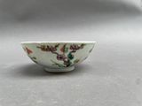 a small white bowl with a floral design on it