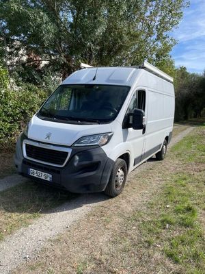 a white van that is parked on the side of the road