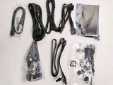 a lot of wires, cords, and other items that are on the table