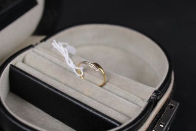 a wedding ring in a ring case with a white string