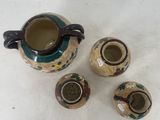 three small vases sitting next to each other on a table