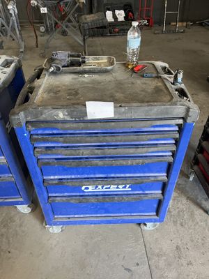 two blue tool boxes are stacked on top of each other in a garage