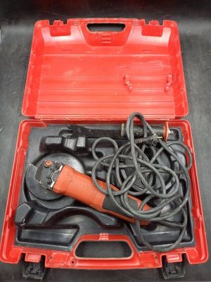 a tool in a red case that is sitting on a table