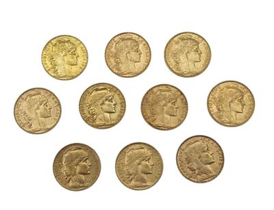 a close up of a bunch of gold coins on a white surface