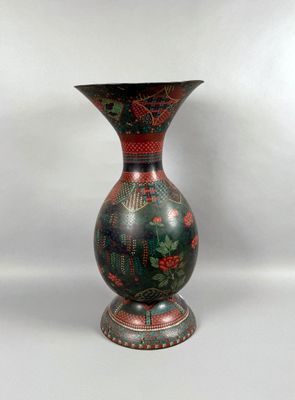 a vase that is sitting on a white surface