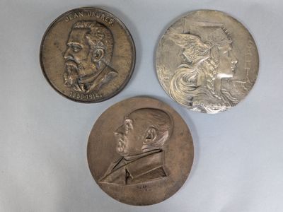 three different types of silver coins on a white surface