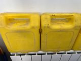 two yellow plastic containers sitting on top of a radiator