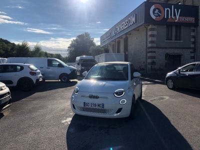 a small white car parked in front of a building