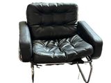 a black leather chair that is sitting on a white background