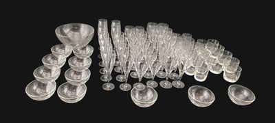 a lot of clear plastic cups and spoons on a black background