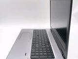a silver laptop with a black keyboard on a white surface