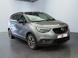 the grey opel is parked in a large room with a black floor