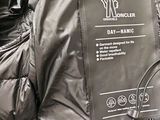 a sleeping bag that is on the ground with a phone in it