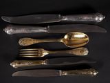 five different types of silverware on a black surface