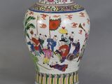 a vase with a painting of people on it