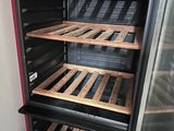a refrigerator that has a bunch of wooden shelves in it
