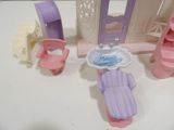 a small doll house with furniture and accessories on the table