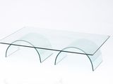 glass coffee table with curved legs and a clear glass top