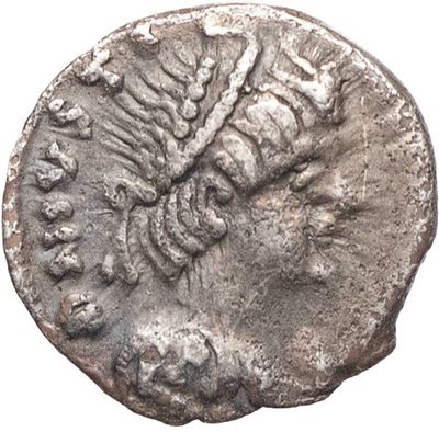a silver coin with a head of a man on it