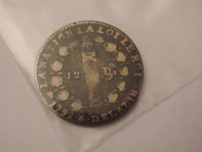 a close up of a coin on a white surface
