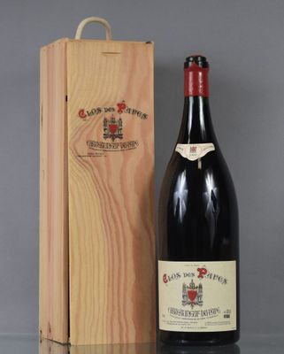 la bouteille de vin rouge se trouve à côté d'une caisse en bois