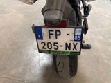 a motorcycle that has a license plate on the back of it
