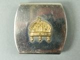 a silver box with a gold crown on top of it