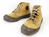 pair of yellow boots with brown soles on a white background
