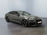 a grey audi rs4 is parked in a white room