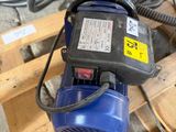 a blue blower sitting on top of a wooden pallet