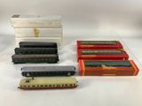 four different model trains are sitting on a table next to each other