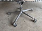 an image of a desk chair with wheels on a concrete floor