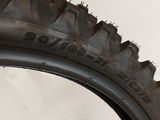 tire tread of a motorcycle with a blue handlebar on the side of the tire