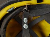 a close up of a fireman ' s helmet with a yellow hose