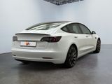 the tesla model s is parked in a white room