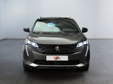 the front view of a grey car in a showroom