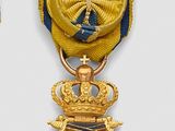 three medals are displayed on a white surface with blue and yellow ribbons
