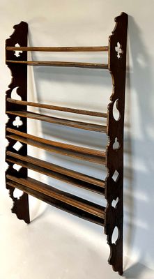 a wooden rack that has a bunch of shelves on it