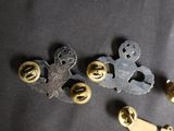 a lot of metal and brass buttons on a black surface