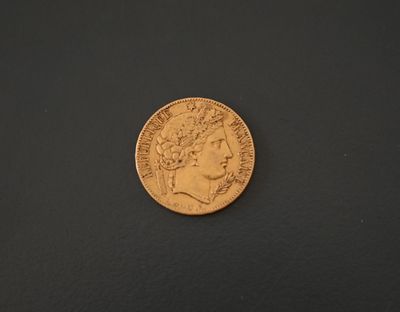 a close up of a gold coin on a black surface