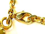 a gold chain with a lock on it on a white surface