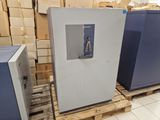 two refrigerators that are sitting on pallets in a warehouse