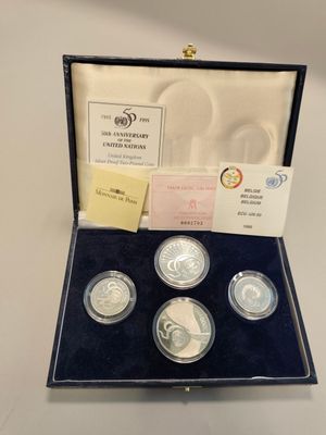 a set of four silver coins in a presentation case