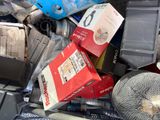 a pile of assorted electronics and other items in a bin