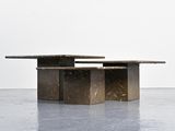 a concrete table with two benches on it in a room