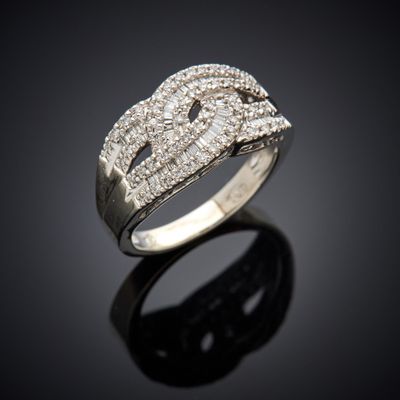 a close up of a diamond ring on a black surface