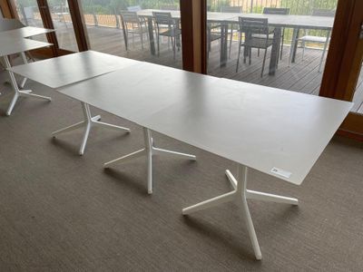 a white table with four chairs in front of a large window