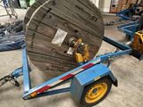 a large reel on a trailer in a warehouse
